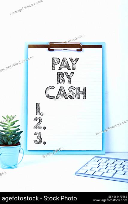 Text sign showing Pay By Cash, Business approach Customer paying with money coins bills Retail shopping Important Message Presented On Clipboard On Desk With...