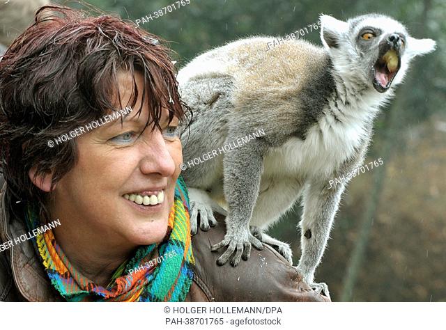 A ring-tailed lemur sits on the shoulder of patient Manuela Staffhorst at Serengeti Park near Hodenhagen, Germany, 10 April 2013