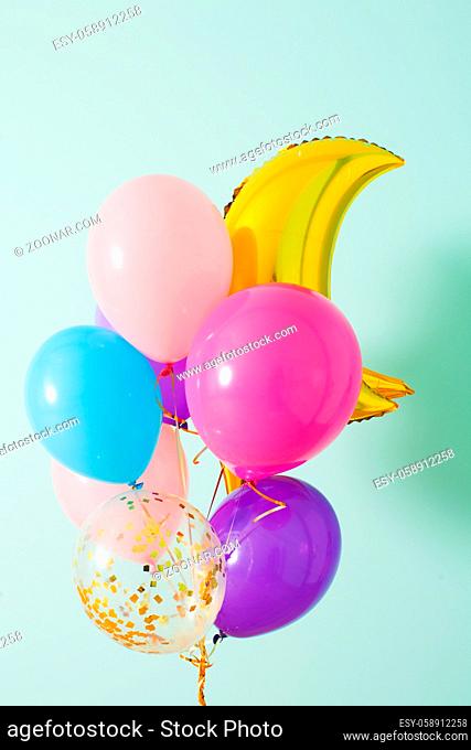 Close up of the bunch of colorful balloons with golden moon