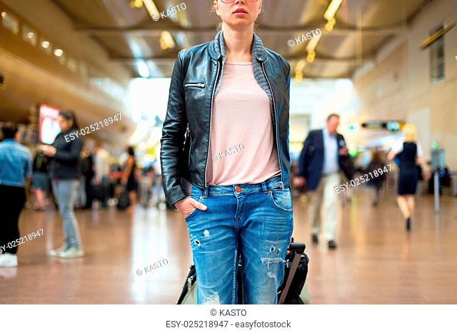 Female traveller walking airport terminal