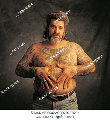 Man with tatoos and piercing
