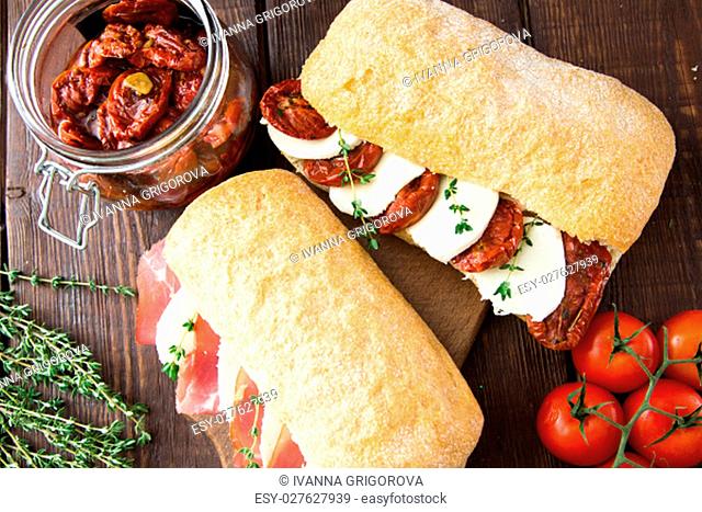 assorted sandwiches. sandwich Caprese with mozzarella and sun-dried tomatoes and ciabatta with ham