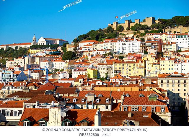 The residential houses of Alfama with Saint George Castle on the hilltop on the background as seen from the observation platform of Santa Justa Lift