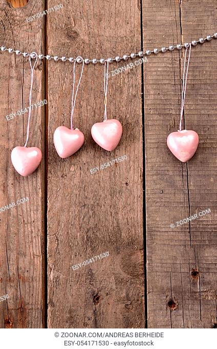 Vintage heart shapes on a rustic wooden background, love concept