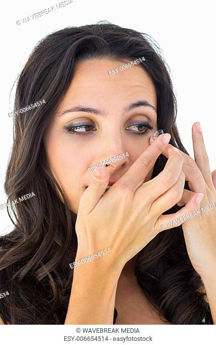 Pretty brunette putting in contact lens