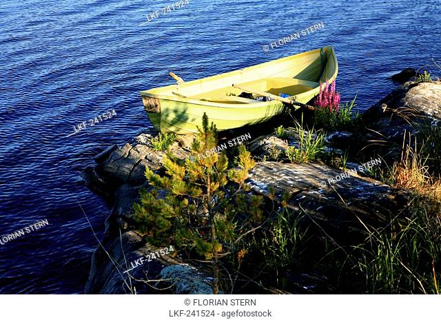 Rowing boat at the shore of an uninhabited island, Saimaa Lake District, Finland, Europe