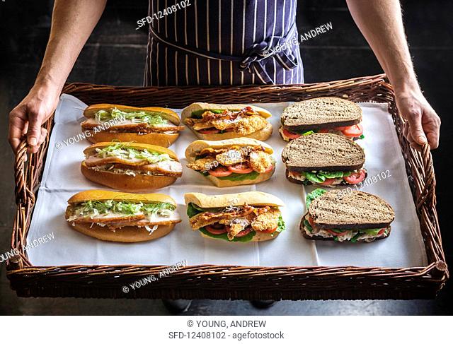 Mixed gourmet sandwiches on a wicker tray
