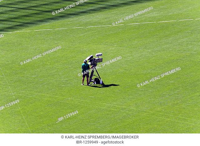 Cameraman standing alone on the lawn at the World Championships in Athletics, IAAF, 2009, in Berlin's Olympic Stadium, Berlin, Germany, Europe