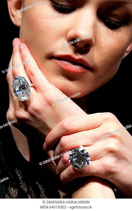 A model holds 51.71 carat white round brilliant cut and 50.39 carat white oval diamonds at Sotheby’s London. The diamonds will be at an auction in Geneva on 15...