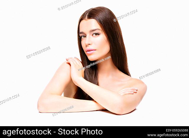 Beautiful young woman with long hair touching shoulder. Isolated over white backgound. Copy space
