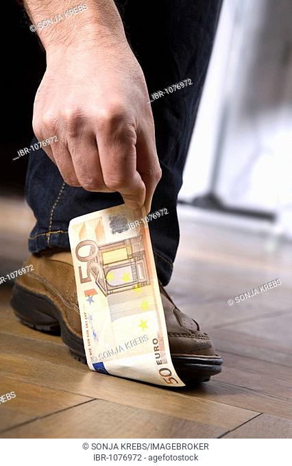 Man standing on a 50 Euro bill
