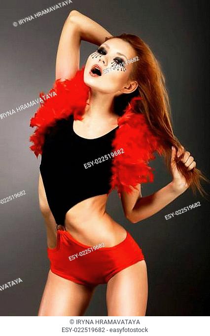 Showgirl. Amazing Red Hair Asian Woman with Fantastic Makeup in Clubwear