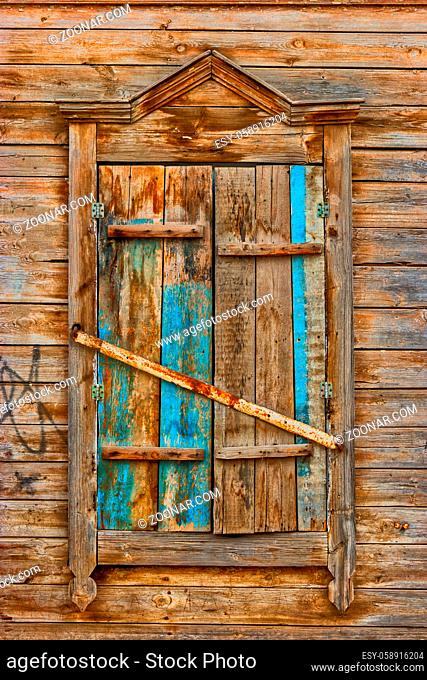 Weathered wooden window in slums