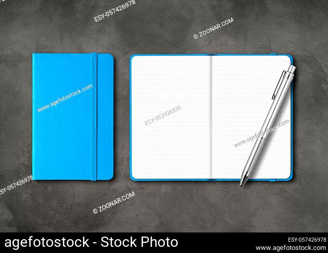 Blue closed and open lined notebooks with a pen. Mockup isolated on dark concrete background