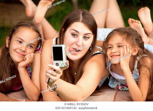 portrait of mother and daughters making faces on self shot