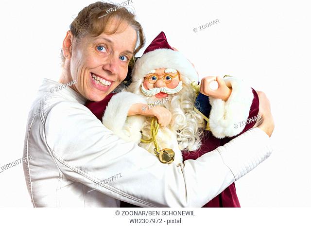 Caucasian woman embracing model of Santa Claus