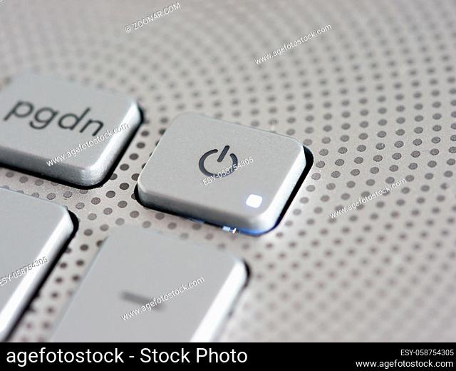 Silver laptop power button close up. Shallow DOF
