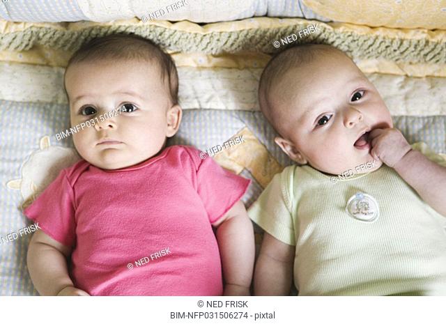 Portrait of two babies on blanket