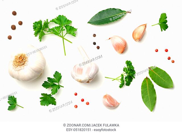 Garlic, bay leaves, parsley, allspice and pepper isolated on white background. Top view