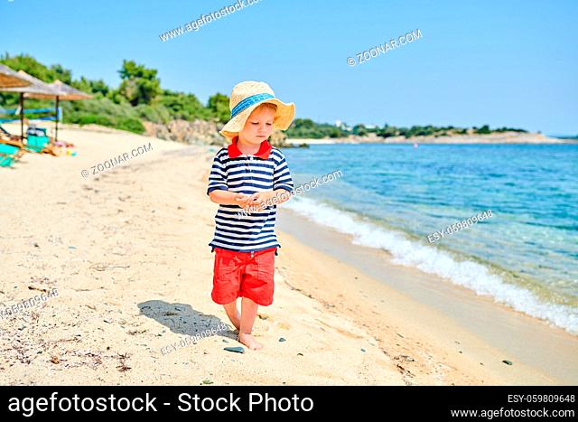 Two year old toddler boy on beach