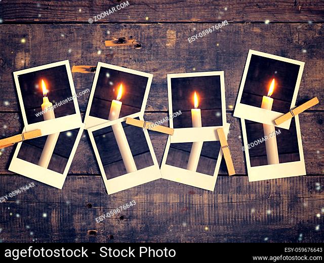 Old instant photograph with four candles on a rustic wooden background, Advent concept background retro film stylized