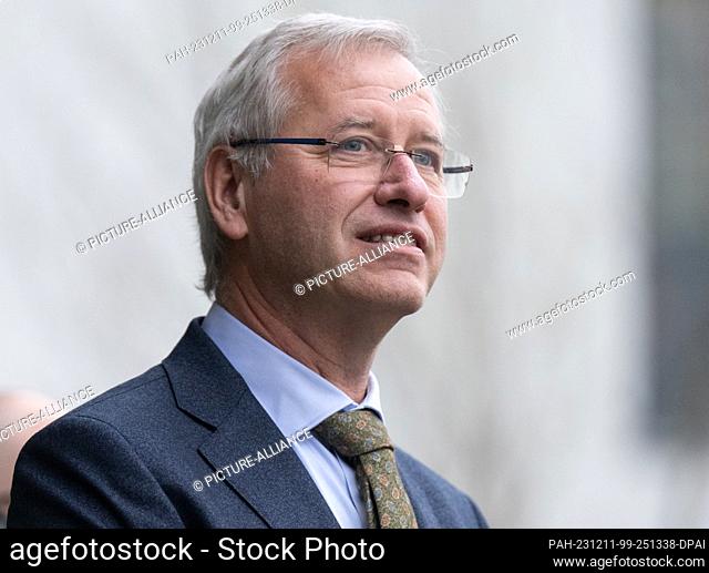 07 December 2023, Saxony, Dresden: Rudi De Winter, Managing Director of the X-FAB Group, waits in front of the company building for the Belgian royal couple