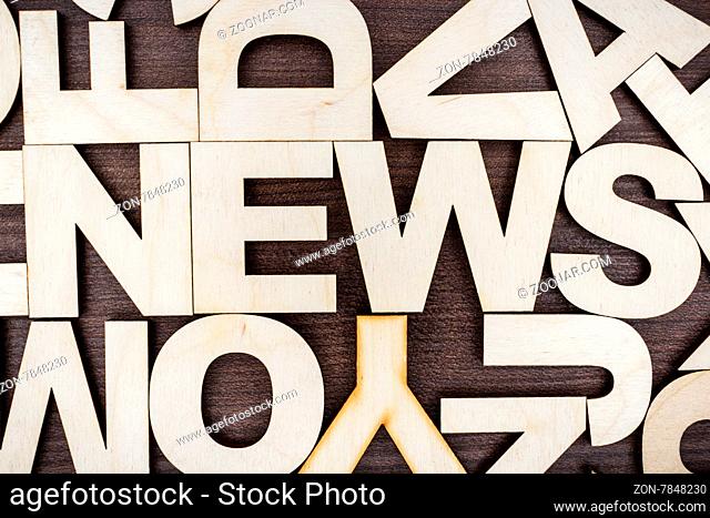 word news on the brown wooden background
