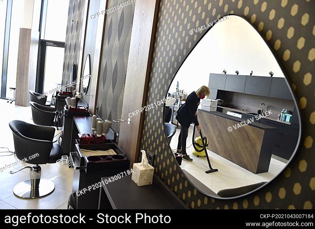A hairdresser Kristyna Humlova prepares her salon in the Futurum shopping mall in Brno, for reopening as further coronavirus lockdown restrictions are lifted in...