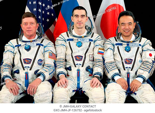 Attired in Russian Sokol launch and entry suits, NASA astronaut Mike Fossum (left), Russian cosmonaut Anatoly Ivanishin (center) and Japan Aerospace Exploration...