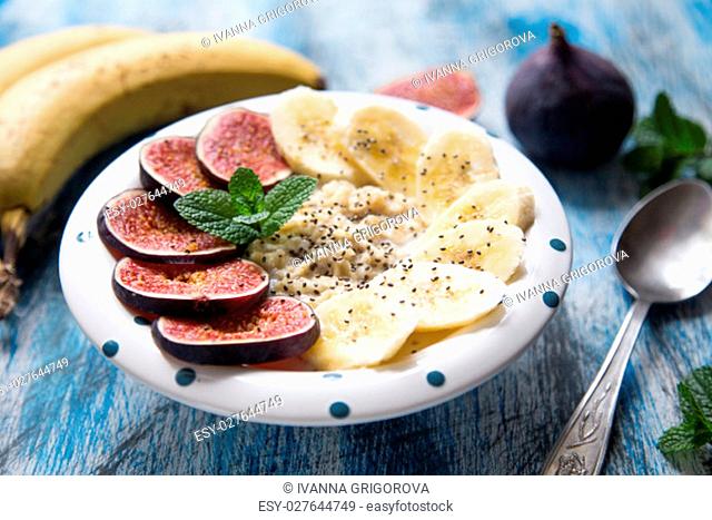 healthy breakfast: oatmeal with fresh figs, bananas, coconut milk and chia seeds