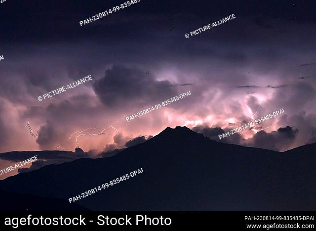 13 August 2023, France, Savines-Le-Lac: View from the French Western Alps across Lac de Serre-Poncon towards a severe thunderstorm in the area of Turin (Italy)