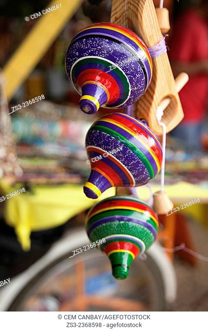Colorful whipping tops at the market stall in town center, Isla Mujeres, Cancun, Quintana Roo, Yucatan Province, Mexico, Central America