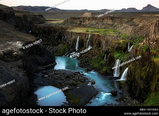 a canyon in the icelandic highlands with waterfalls