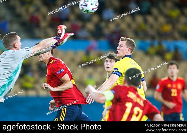 14 June 2021, Spain, Sevilla: Football: European Championship Group E, Spain - Sweden: Sweden's goalkeeper Robin Olsen clears from Sweden's Emil Krafth as...