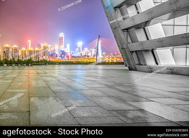 empty marble floor and modern suspension bridge and cityscape of chongqing at night