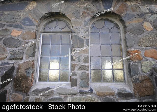 Picture of the window of church at stone wall