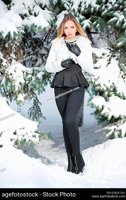 Charming young woman posing in winter