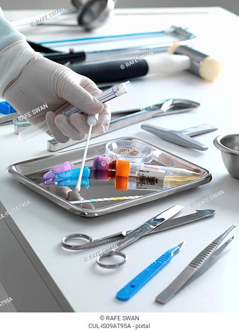 Pathologist taking a DNA sample for analysis during a autopsy