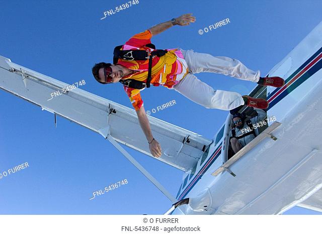 Skydiver jumping off airplane