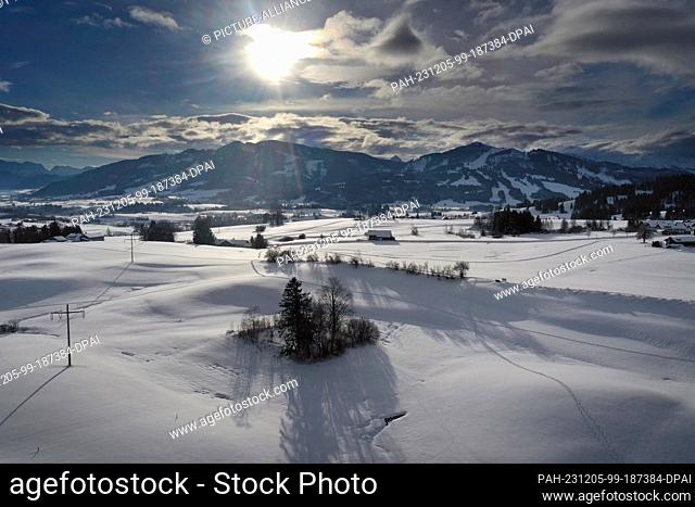 05 December 2023, Bavaria, Oy-Mittelberg: The Allgäu foothills of the Alps are covered in deep snow (aerial view with a drone)