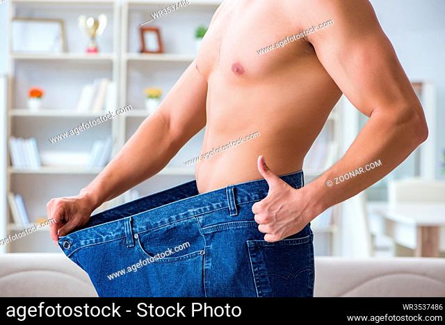 A woman shows a weight loss by wearing old big pants. The concept of weight  loss Stock Photo by ©TanyaLovus 173564818