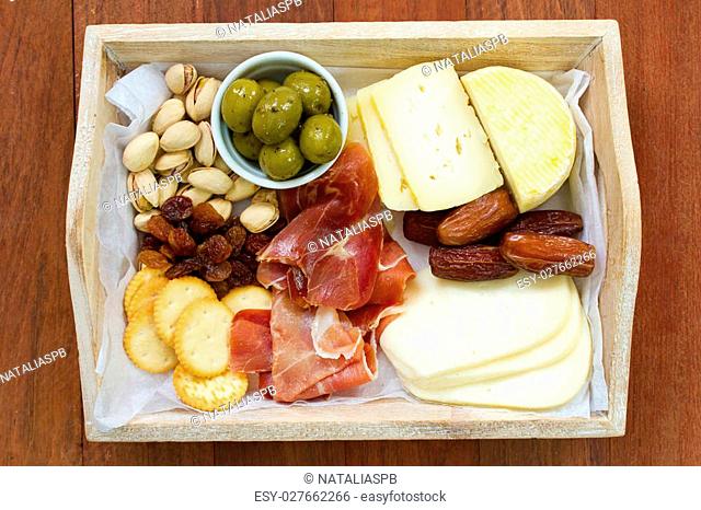cheese with prosciutto, cookies, olives