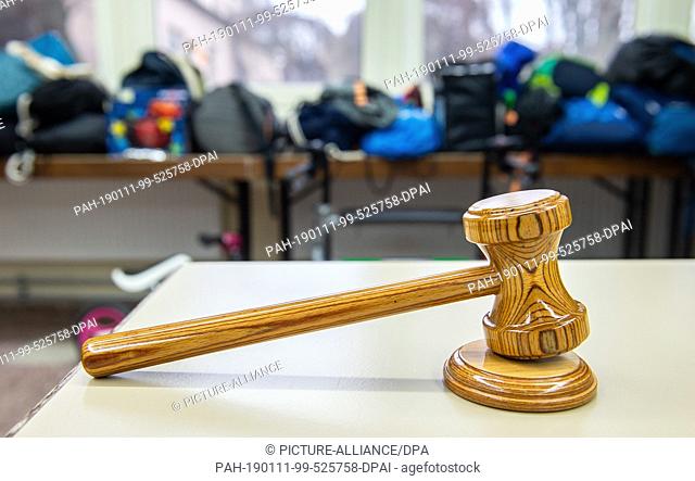 11 January 2019, Hessen, Frankfurt/Main: A wooden hammer stands on a table before the start of an auction in the lost property office of the Frankfurt Transport...
