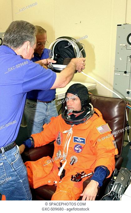 05/30/2002 - STS-111 Pilot Paul Lockhart waits for his helmet during suitup for the scheduled liftoff of Space Shuttle Endeavour at 7:44 p.m. EDT