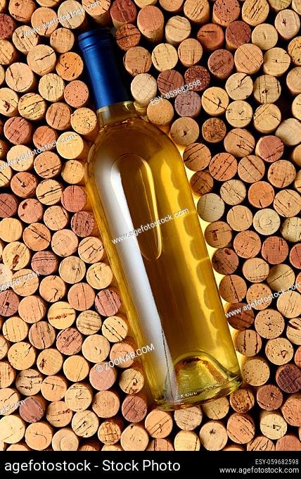 White Wine: A bottle of Sauvignon Blanc surrounded by corks standing on end filling the frame. Bottle has no label