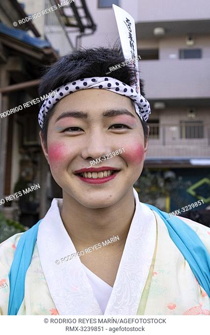 February 24, 2019, Tokyo, Japan - A man dressed in women's kimonos and wearing makeup, poses for a photograph during the Ikazuchi no Daihannya festival