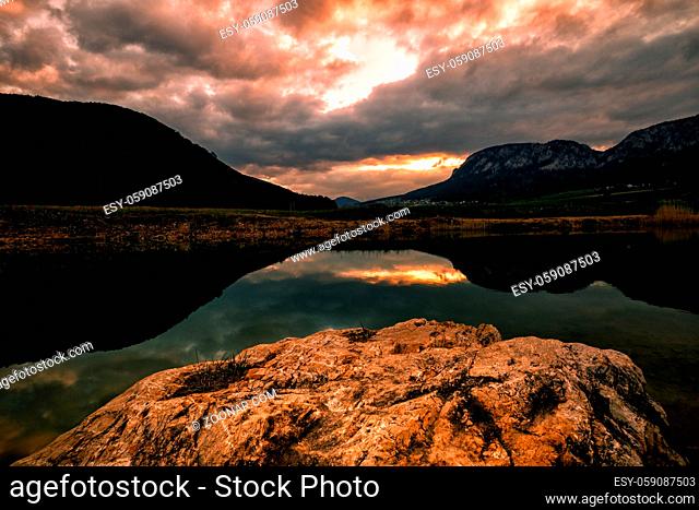 Small lake in austrian mountains at the sunset in spring
