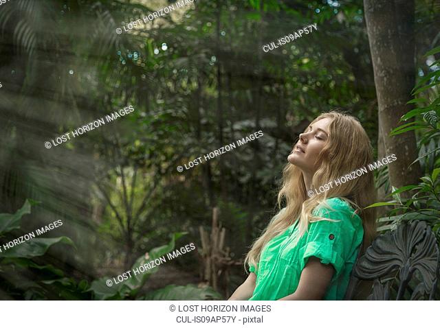 Woman relaxing in forest