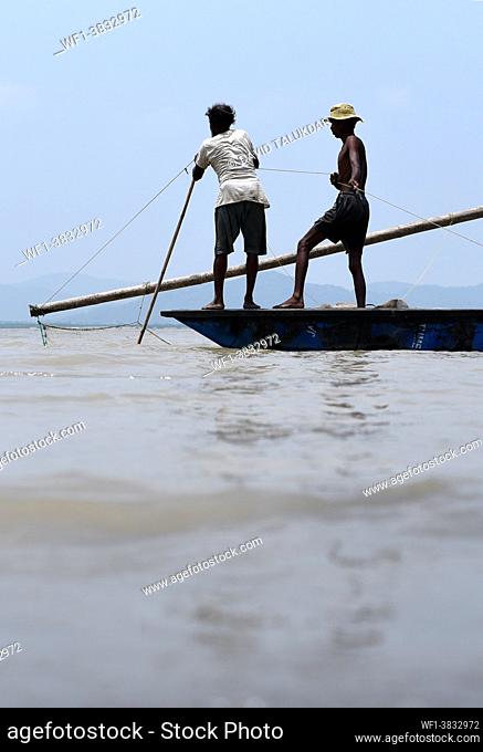 Fishermen lay fishing net in the in the Brahmaputra river, in Guwahati