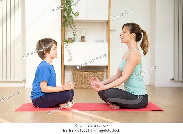 Mother and son practicing meditation